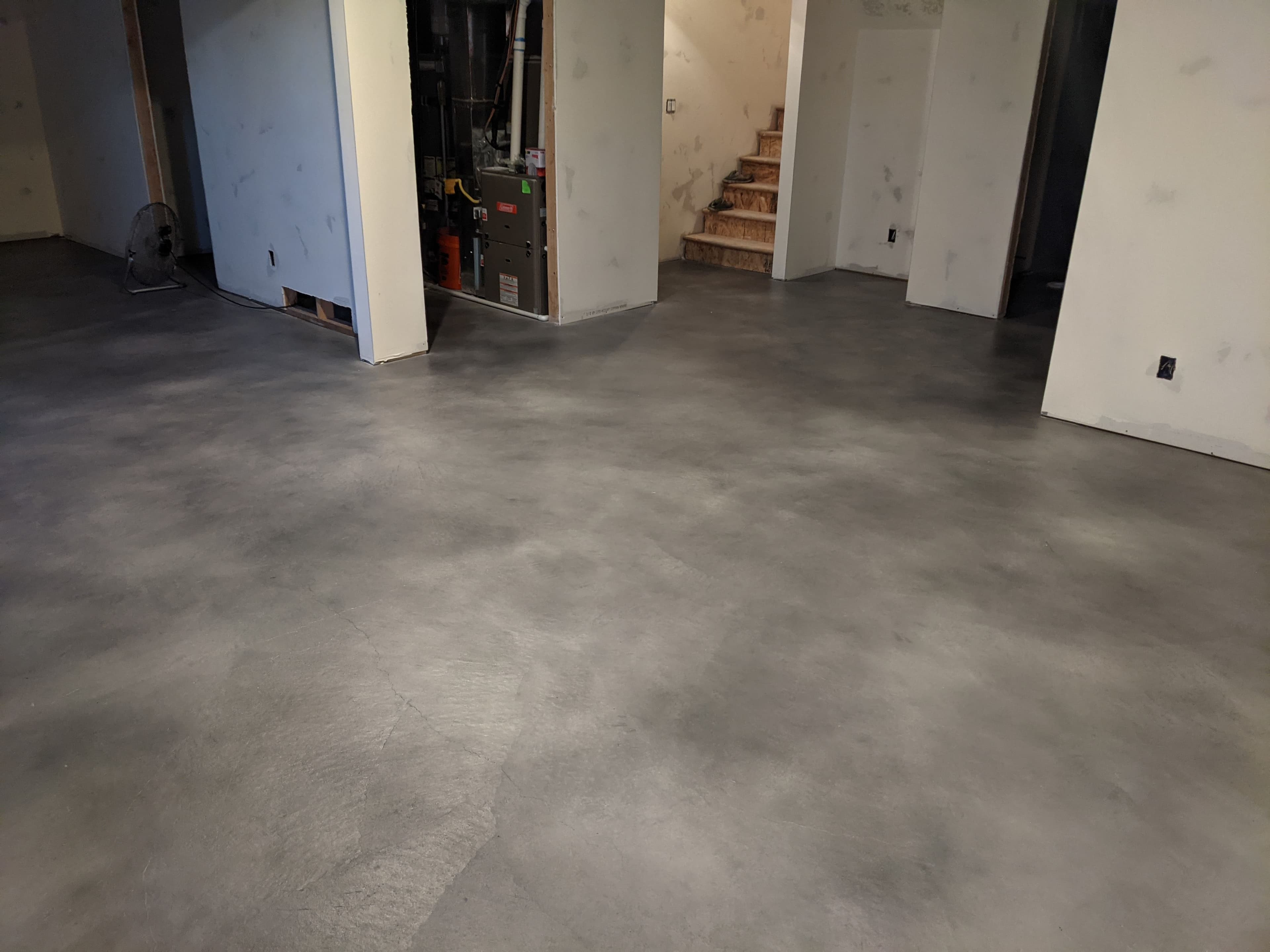 Centerville basement with gray faux stained concrete floor by Bella Rocca