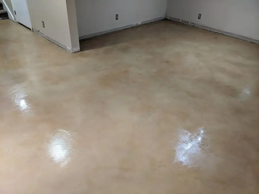 Sandy basement with light tan stained concrete floor by Bella Rocca