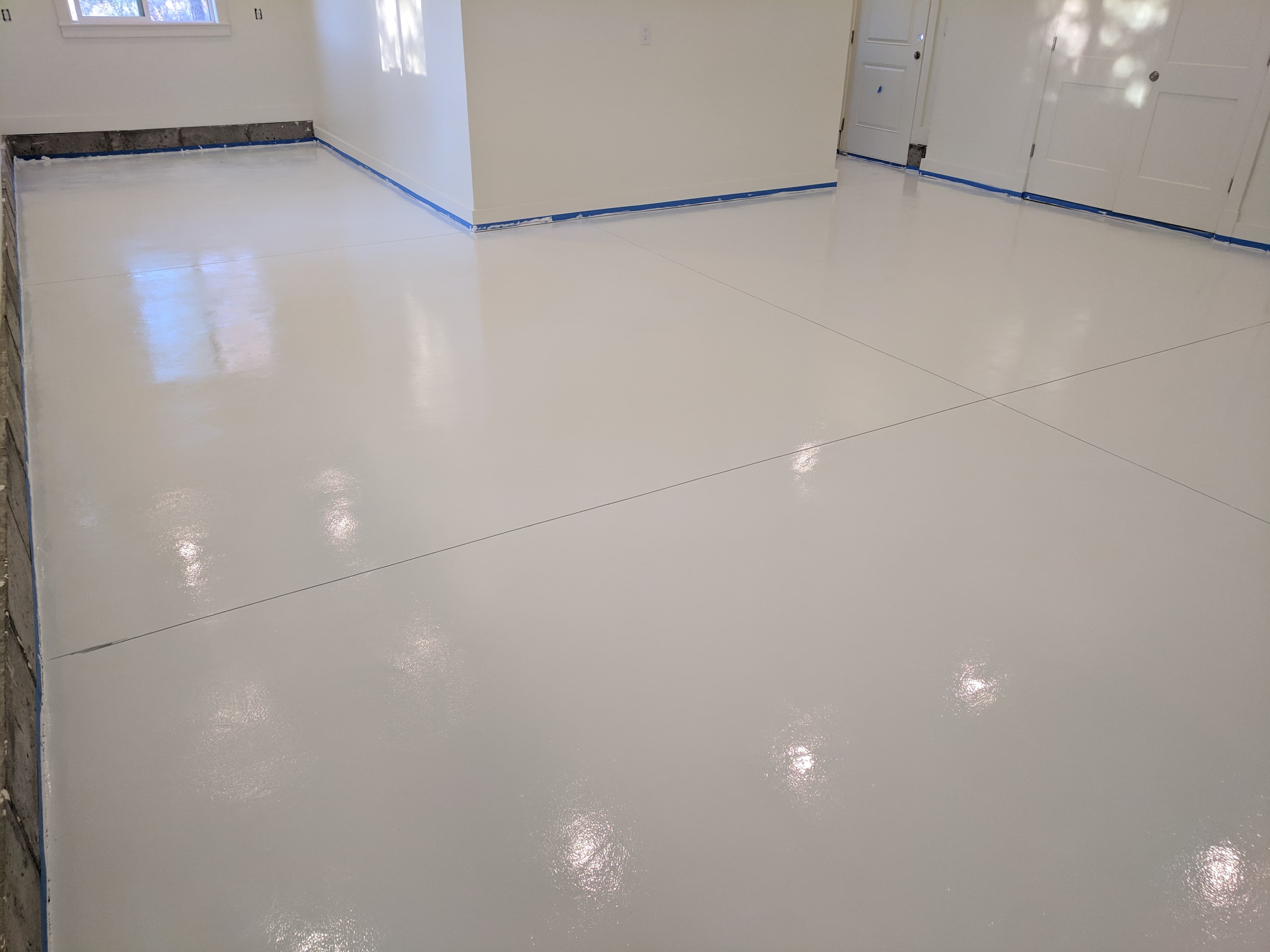 Lehi Utah garage with a bright white epoxy floor completed by Bella Rocca