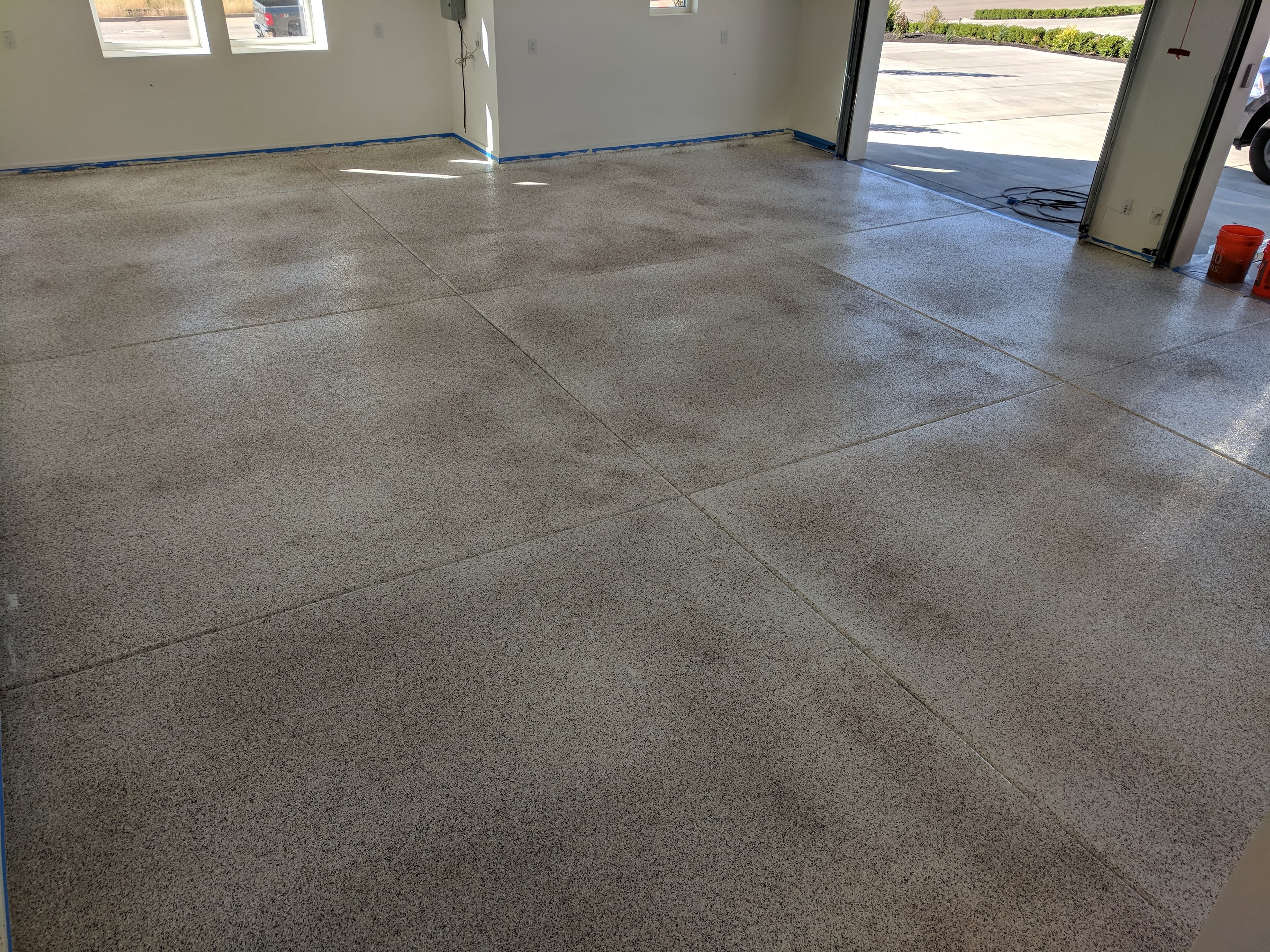 Gray full-flake garage floor completed by Bella Rocca