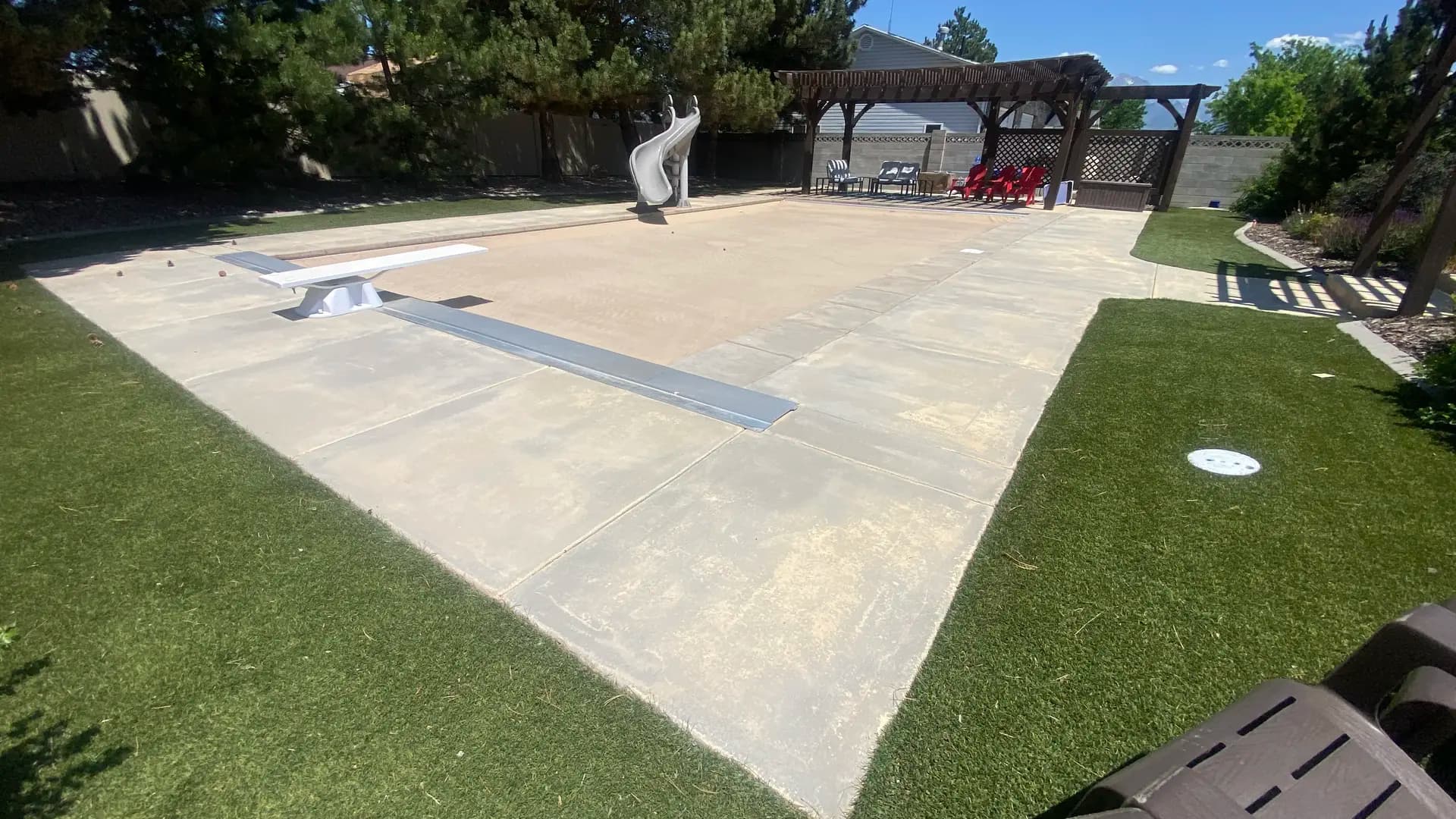 Weathered residential pool deck before Bella Rocca restored the decorative concrete finish