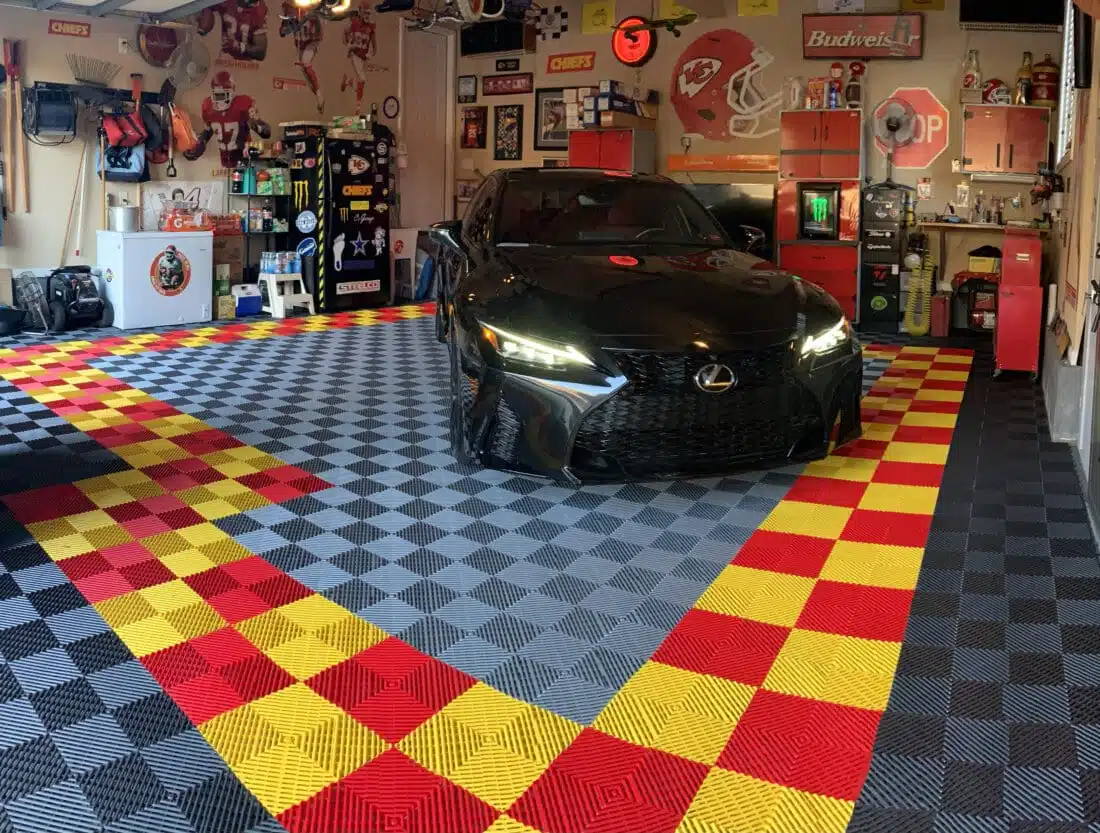 Garage with a vehicle parked on TrueLock HD Ribbed modular garage flooring